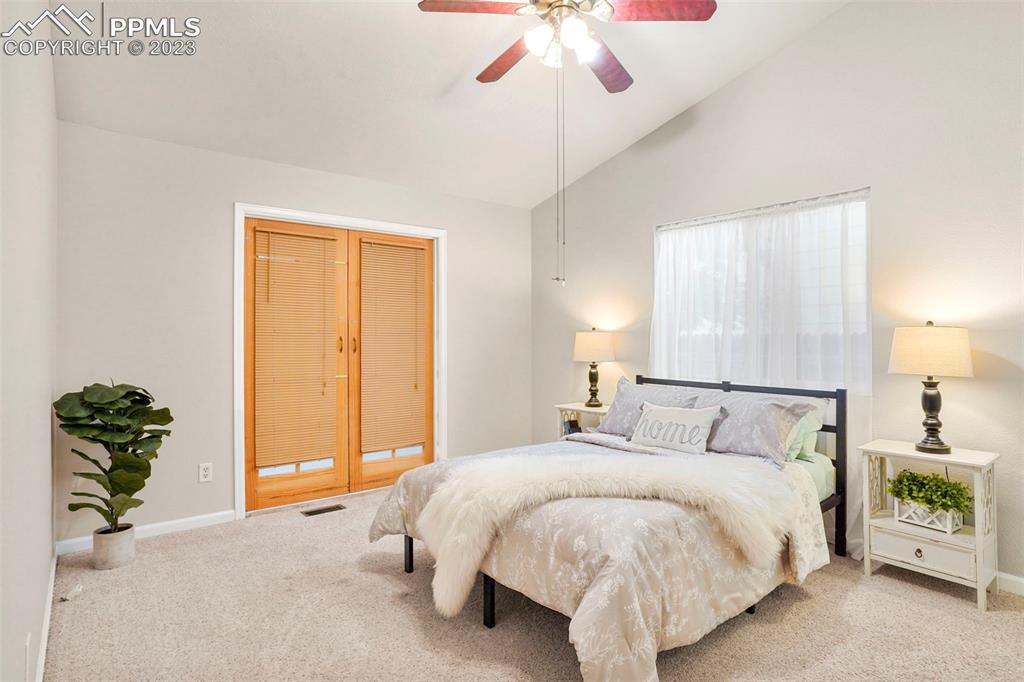 4748 Brant Road Colorado Springs, CO 80911 - Photo 9 of 19 a bed room with a bed and a chandelier