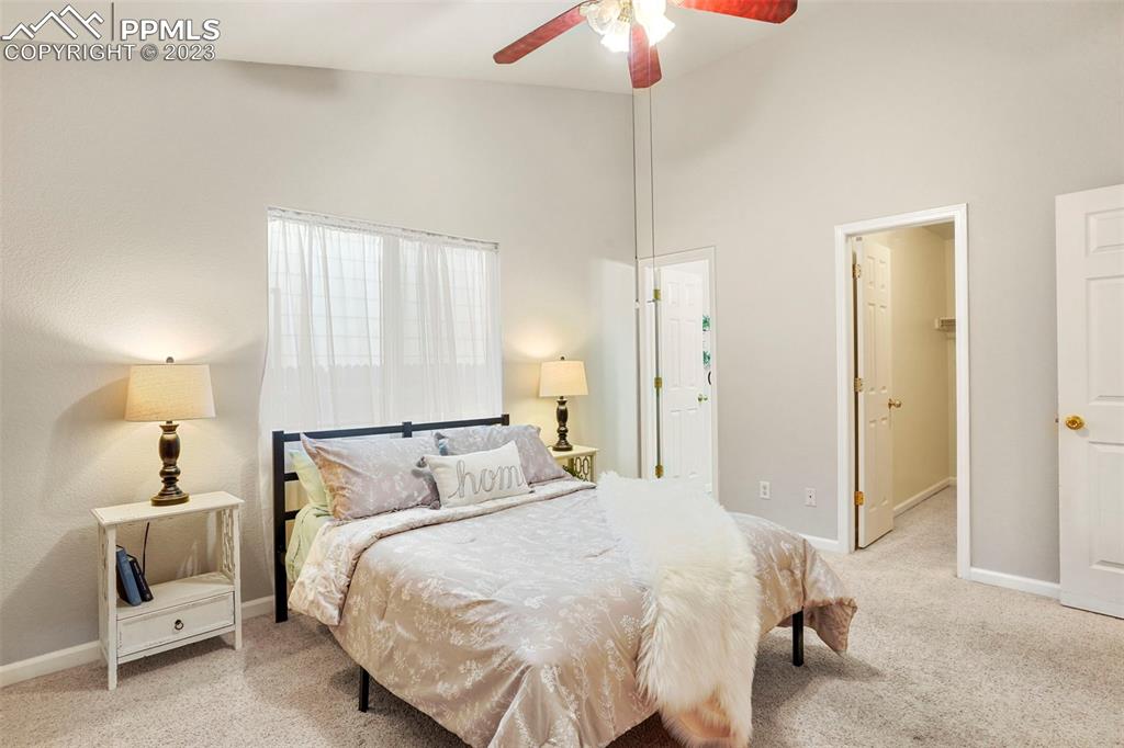4748 Brant Road Colorado Springs, CO 80911 - Photo 10 of 19 a bedroom with a bed and a chandelier