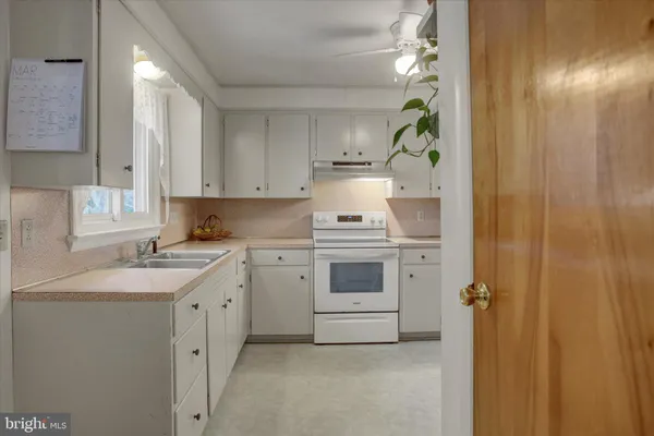 a kitchen with a stove top oven sink and cabinets