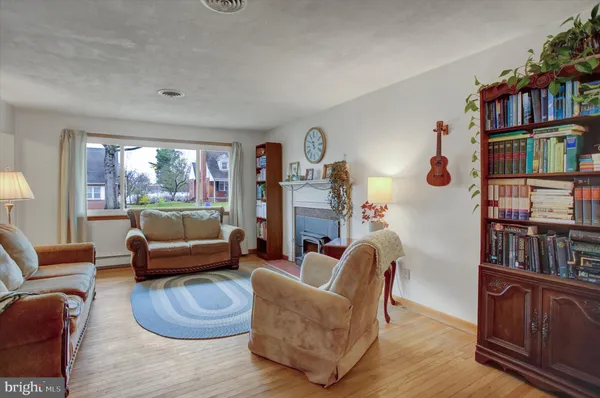 a living room with furniture and a book shelf