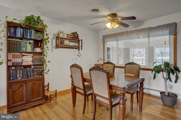 a dining room with furniture and wooden floor