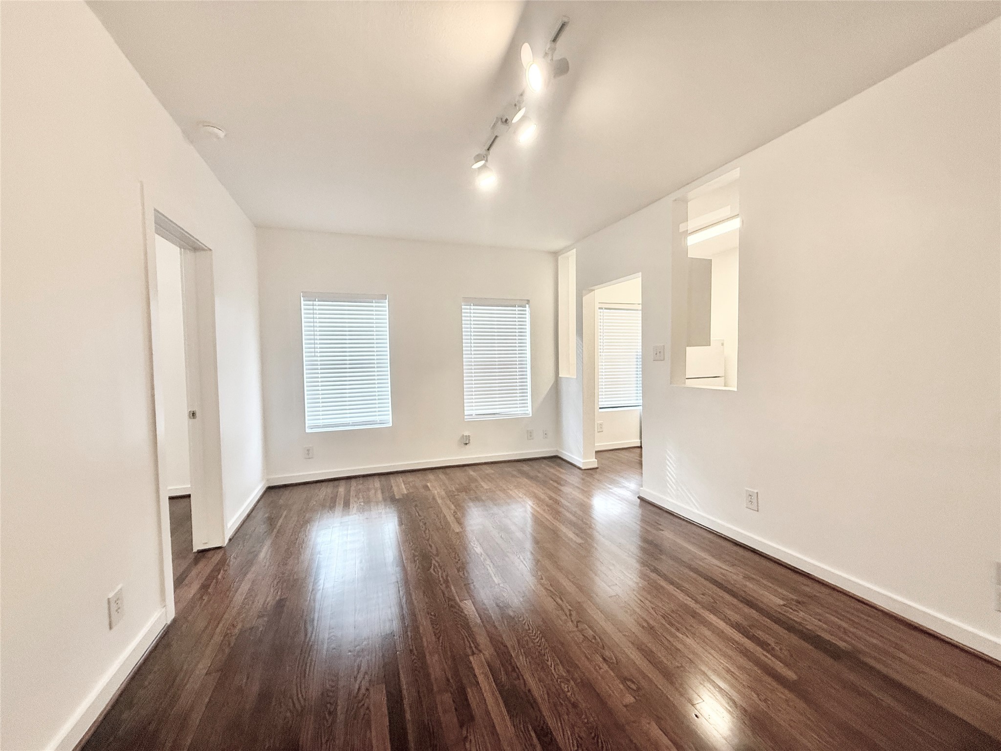 4021 Mandell Street, Unit D Houston, TX 77006 - Photo 3 of 13 an empty room with wooden floor and windows
