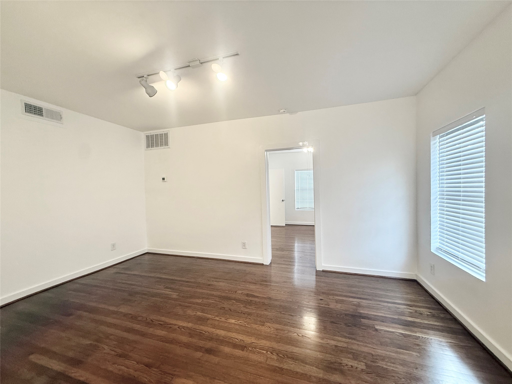 4021 Mandell Street, Unit D Houston, TX 77006 - Photo 5 of 13 wooden floor in an empty room with a window
