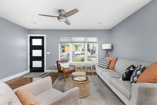a living room with furniture and wooden floor