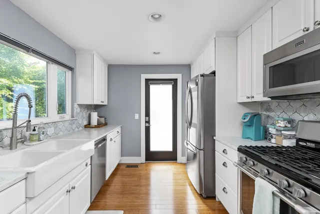 a kitchen with stainless steel appliances granite countertop a sink stove and refrigerator