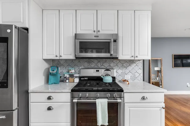 a stove top oven sitting inside of a kitchen