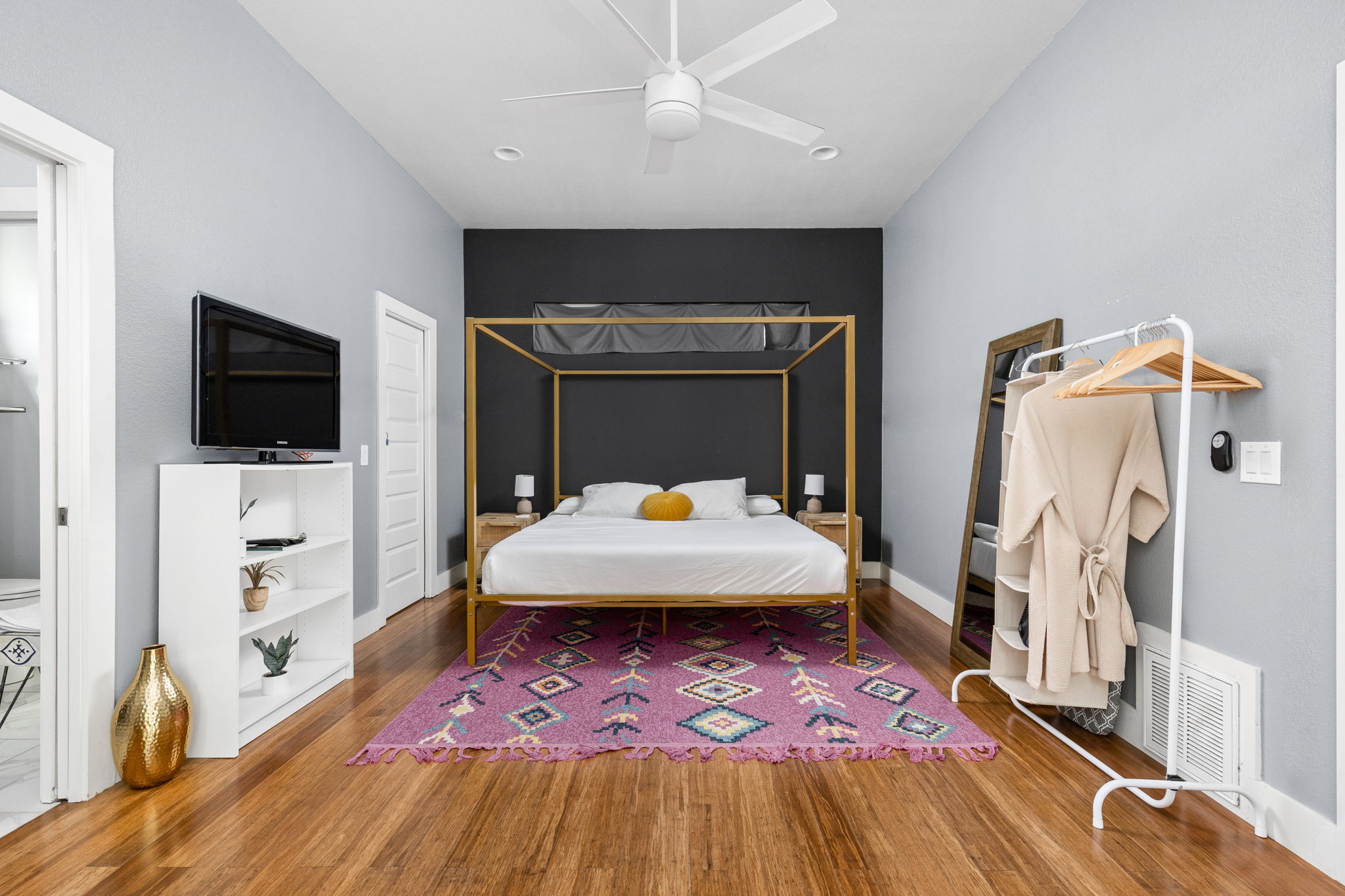 7611 Providence Avenue, Unit A Austin, TX 78752 - Photo 19 of 40 a bedroom with a bed and a flat screen tv