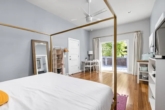 a bedroom with a bed and a large window