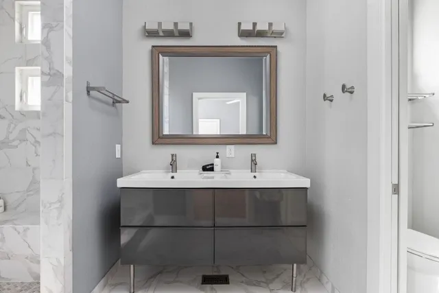 a bathroom with a sink and a mirror