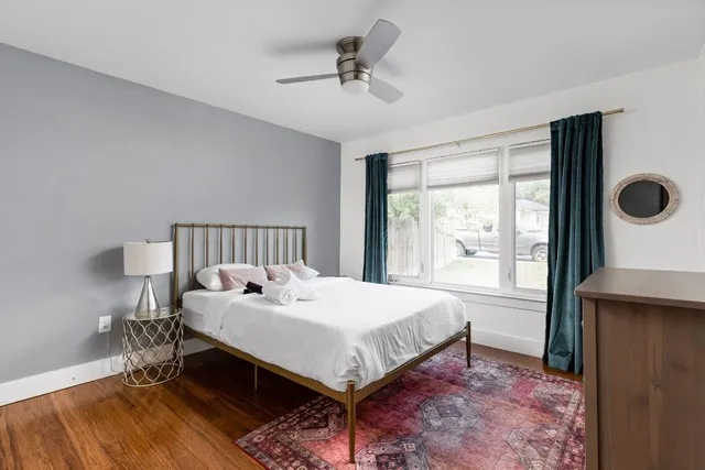 a bed sitting in a bedroom next to a window