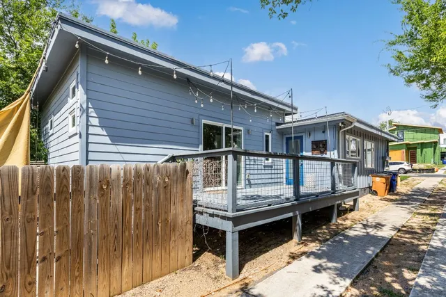 a view of a brick house with large windows