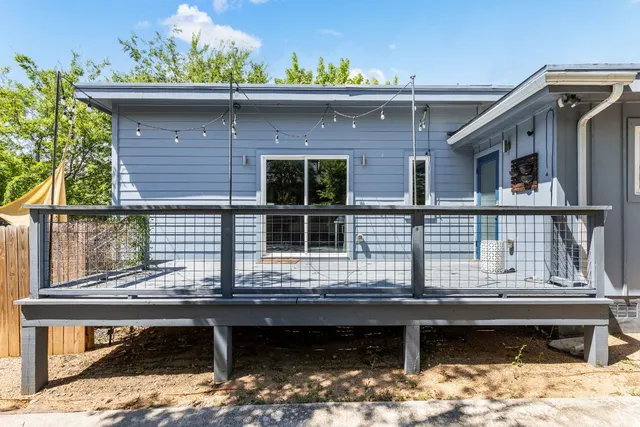 an aerial view of a house with a garden and lake view