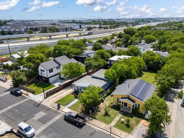an aerial view of a houses with a street