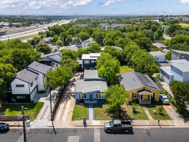 an aerial view of a house with a yard