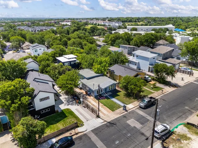 an aerial view of residential houses with outdoor space