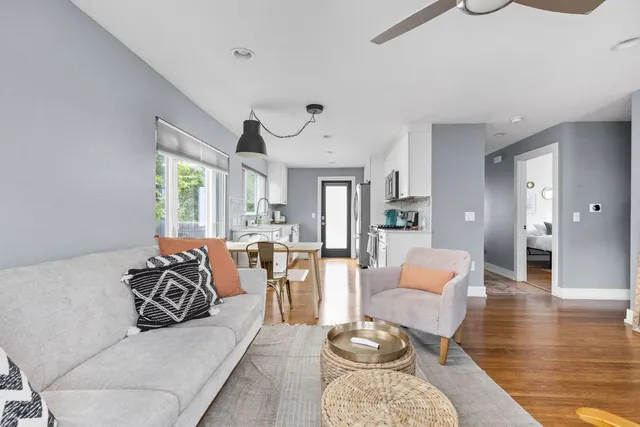 a living room with furniture or couch and a chandelier