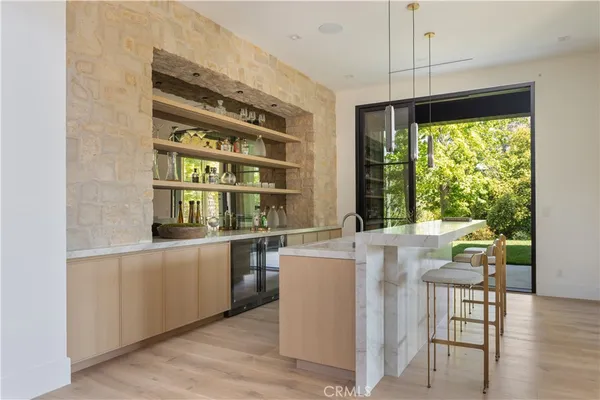 a kitchen with stainless steel appliances a stove and a large window