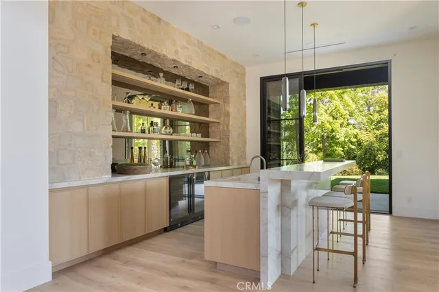 a kitchen with stainless steel appliances a stove and a large window