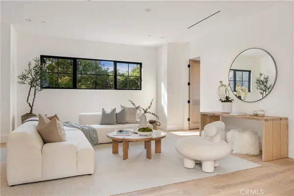 a bedroom with a bed potted plant and a window