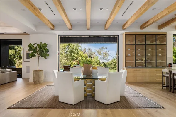 a living room with couches chairs and a large window with garden view