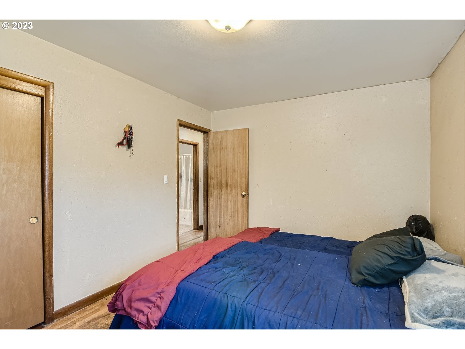 14409 Southeast Oatfield Road Milwaukie, OR 97267 - Photo 12 of 24 a bedroom with a bed and a night stand