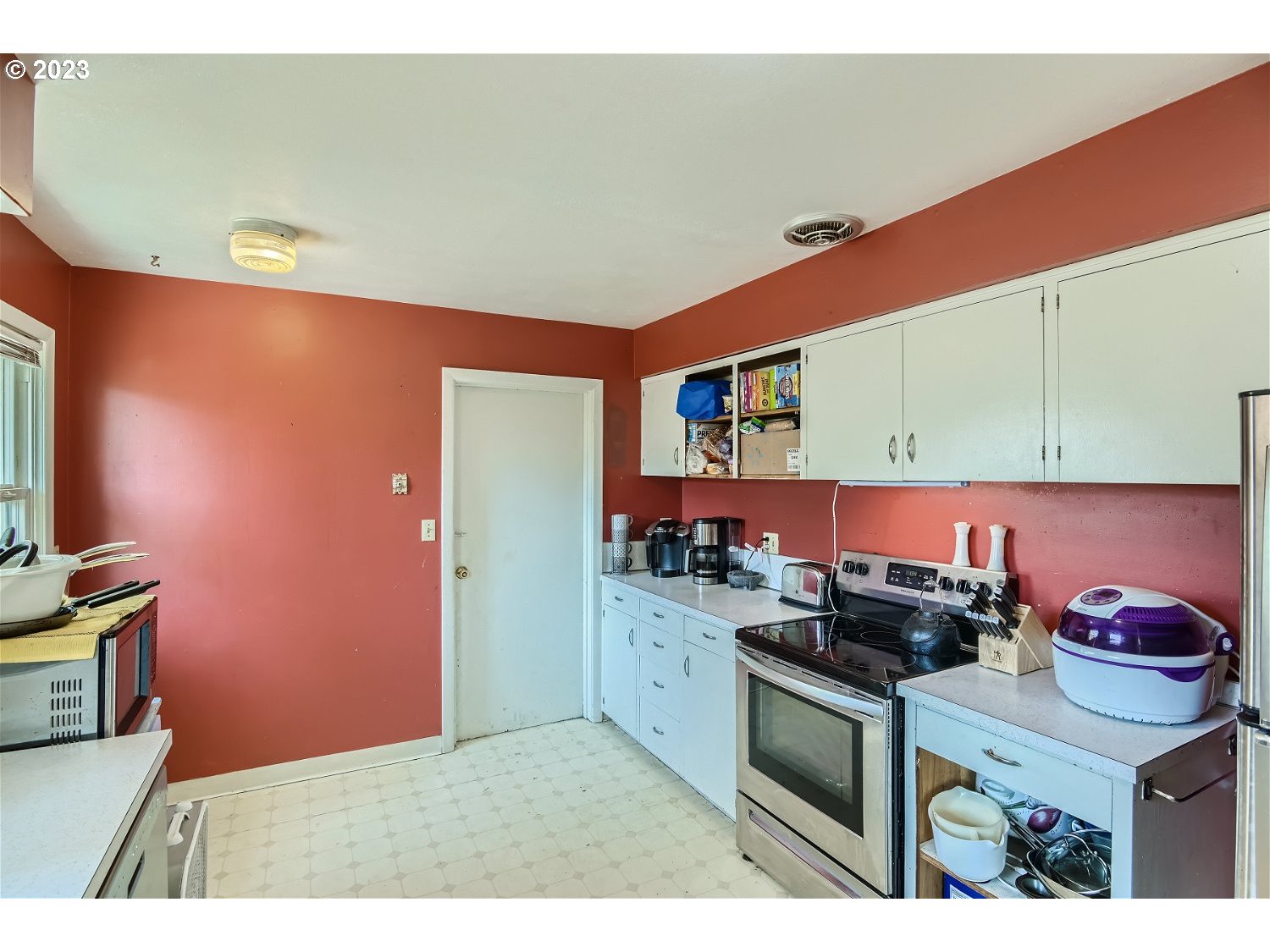 14409 Southeast Oatfield Road Milwaukie, OR 97267 - Photo 9 of 24 a kitchen with stainless steel appliances granite countertop a stove a sink and a microwave