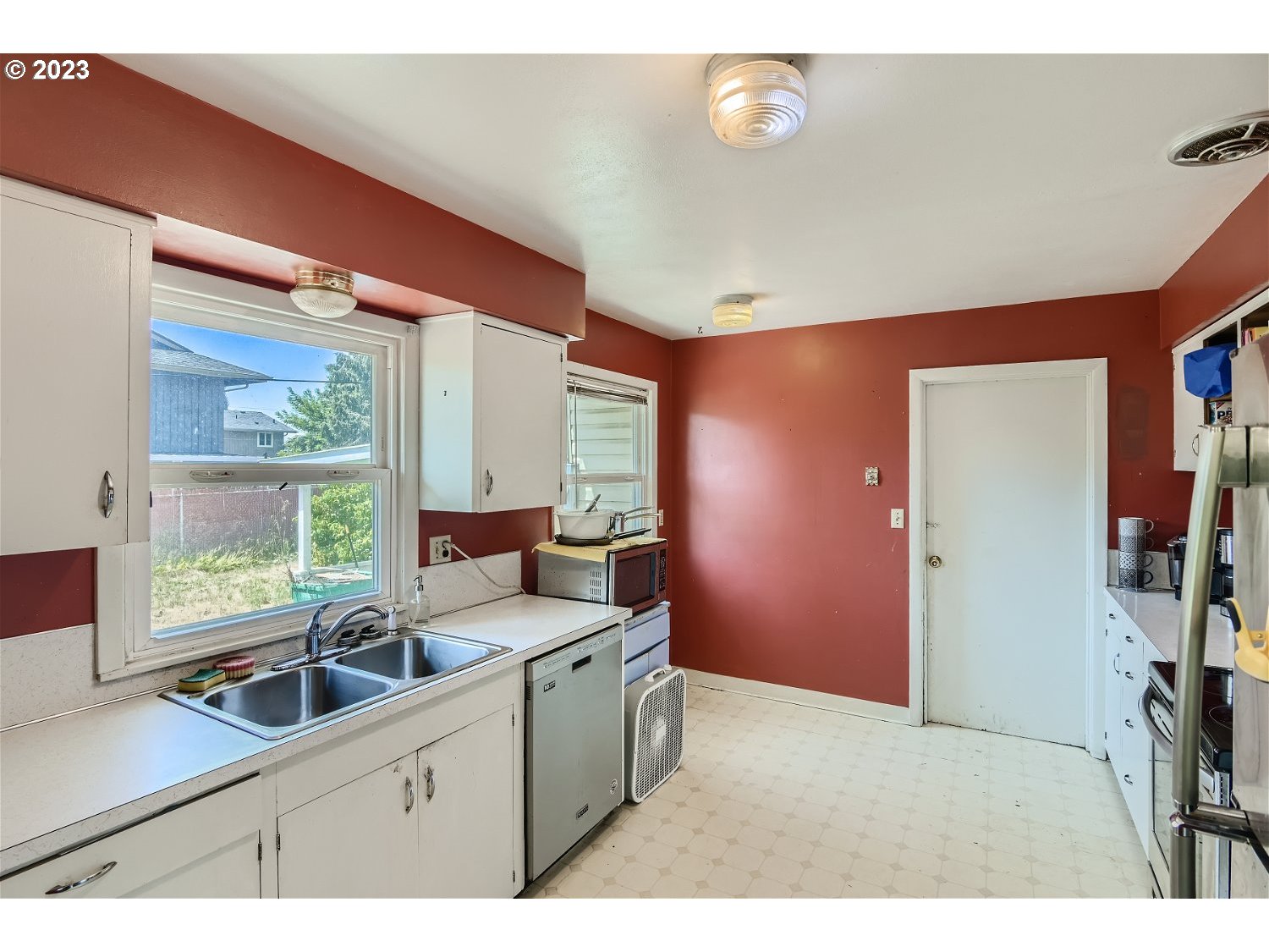 14409 Southeast Oatfield Road Milwaukie, OR 97267 - Photo 10 of 24 a kitchen with a sink cabinets and window