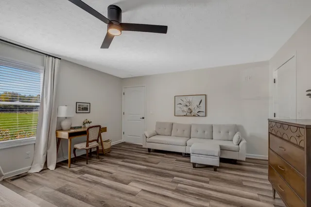 a spacious bedroom with a bed and a chandelier