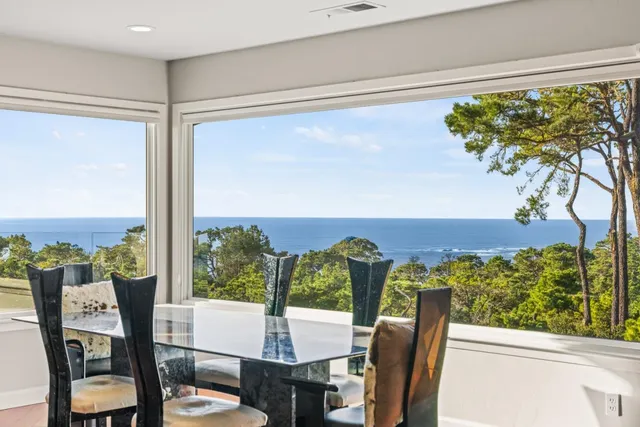 a view of a chairs and table in a balcony