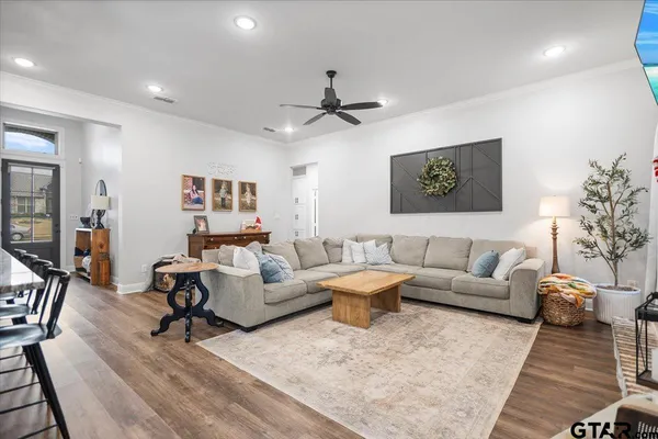 a living room with furniture and wooden floor