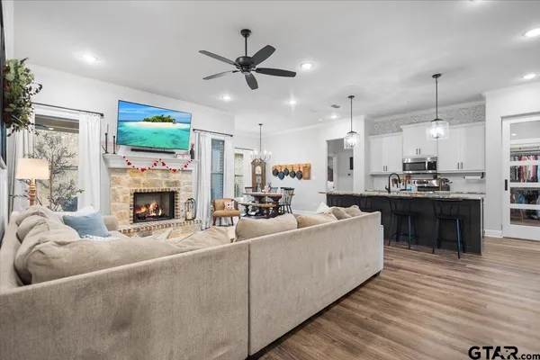 a living room with furniture a fireplace and a flat screen tv