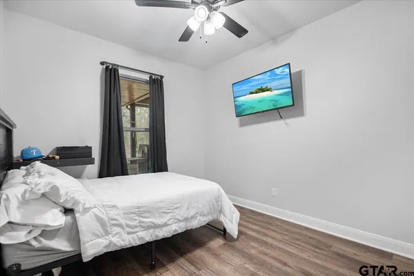 a bedroom with a bed and a chandelier