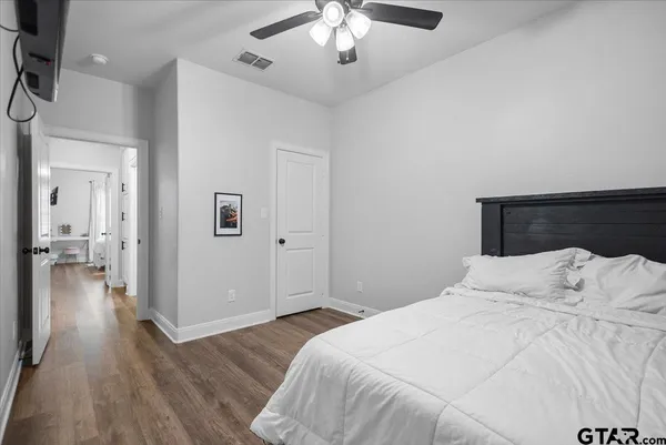 a bedroom with a bed and a chandelier