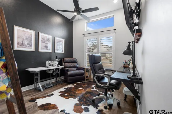 a view of a workspace with furniture and a window