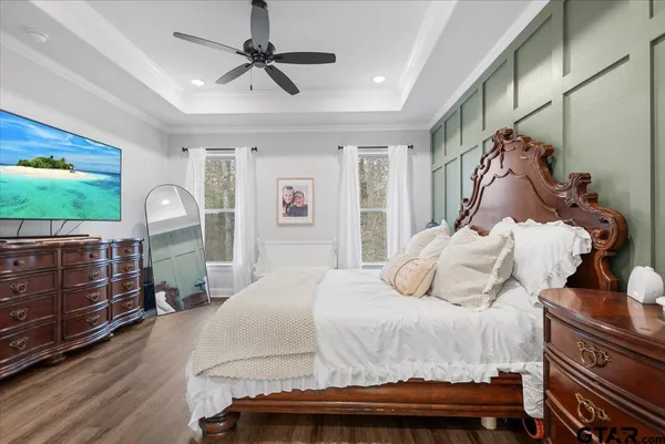 a bedroom with a bed and a chandelier