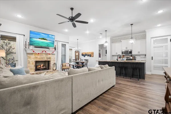 a living room with furniture fireplace and a flat screen tv