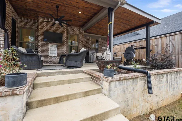 a building outdoor space with patio furniture and potted plants