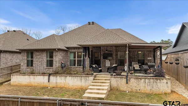 a view of a house with swimming pool and sitting area