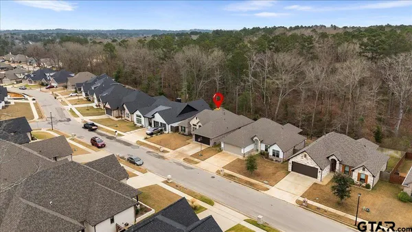 an aerial view of a house with a yard