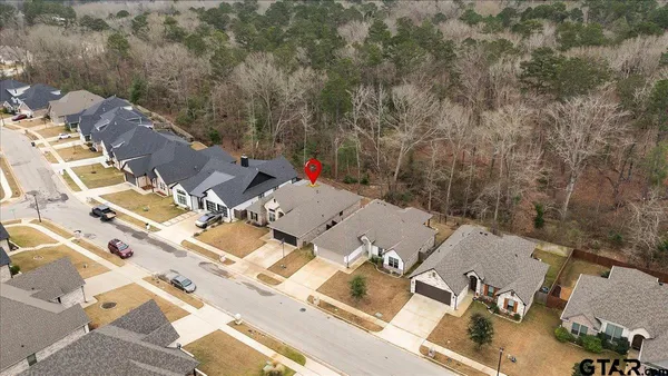 an aerial view of a house with a yard
