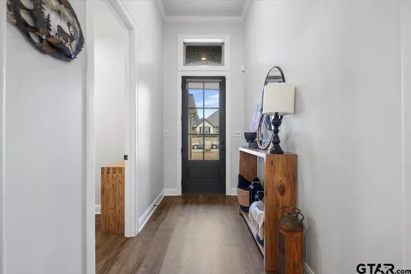 a view of a room that has a bed wooden floor and a window