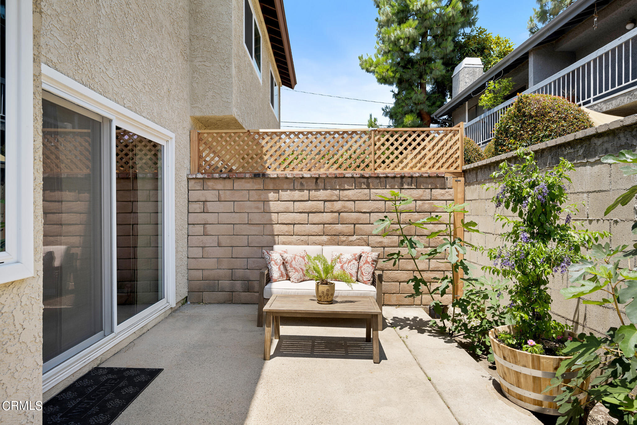2041 Windsor Circle Duarte, CA 91010 - Photo 9 of 19 a white house with a table and chair and potted plants