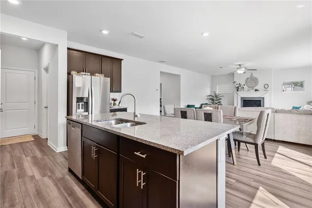 a kitchen with a table chairs refrigerator and cabinets