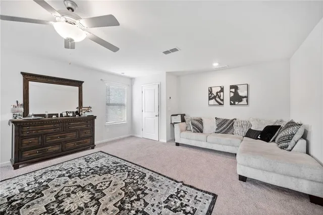 a living room with furniture and a dresser