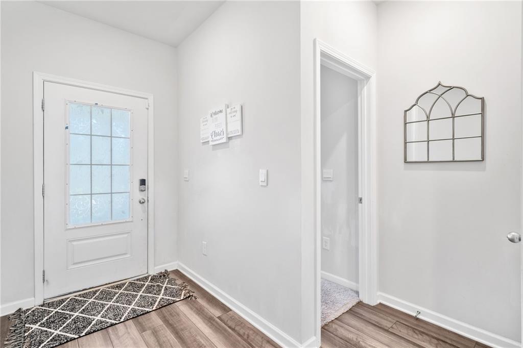 368 Murray Way Lilburn, GA 30047 - Photo 2 of 54 a view of a livingroom with wooden floor and a window