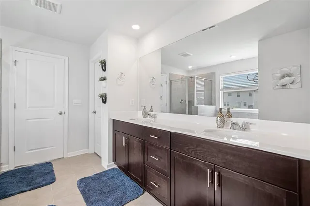 a spacious bathroom with a granite countertop sink a mirror and a