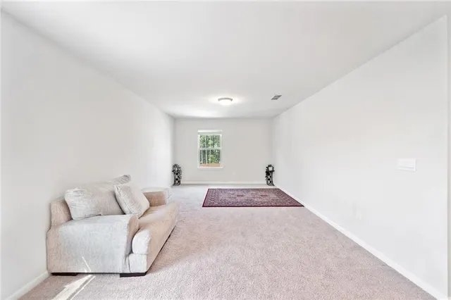 a spacious bedroom with a bed and a couch