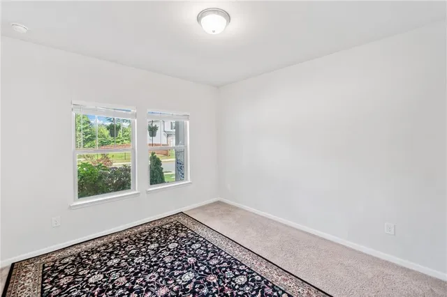 a view of a workspace with furniture and a book shelf