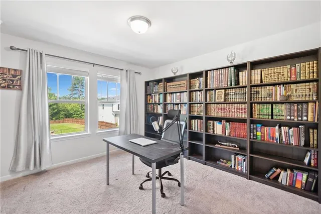 a bedroom with two beds and a window