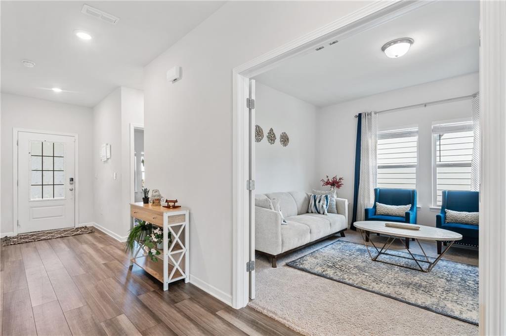 368 Murray Way Lilburn, GA 30047 - Photo 3 of 54 a living room with furniture and wooden floor